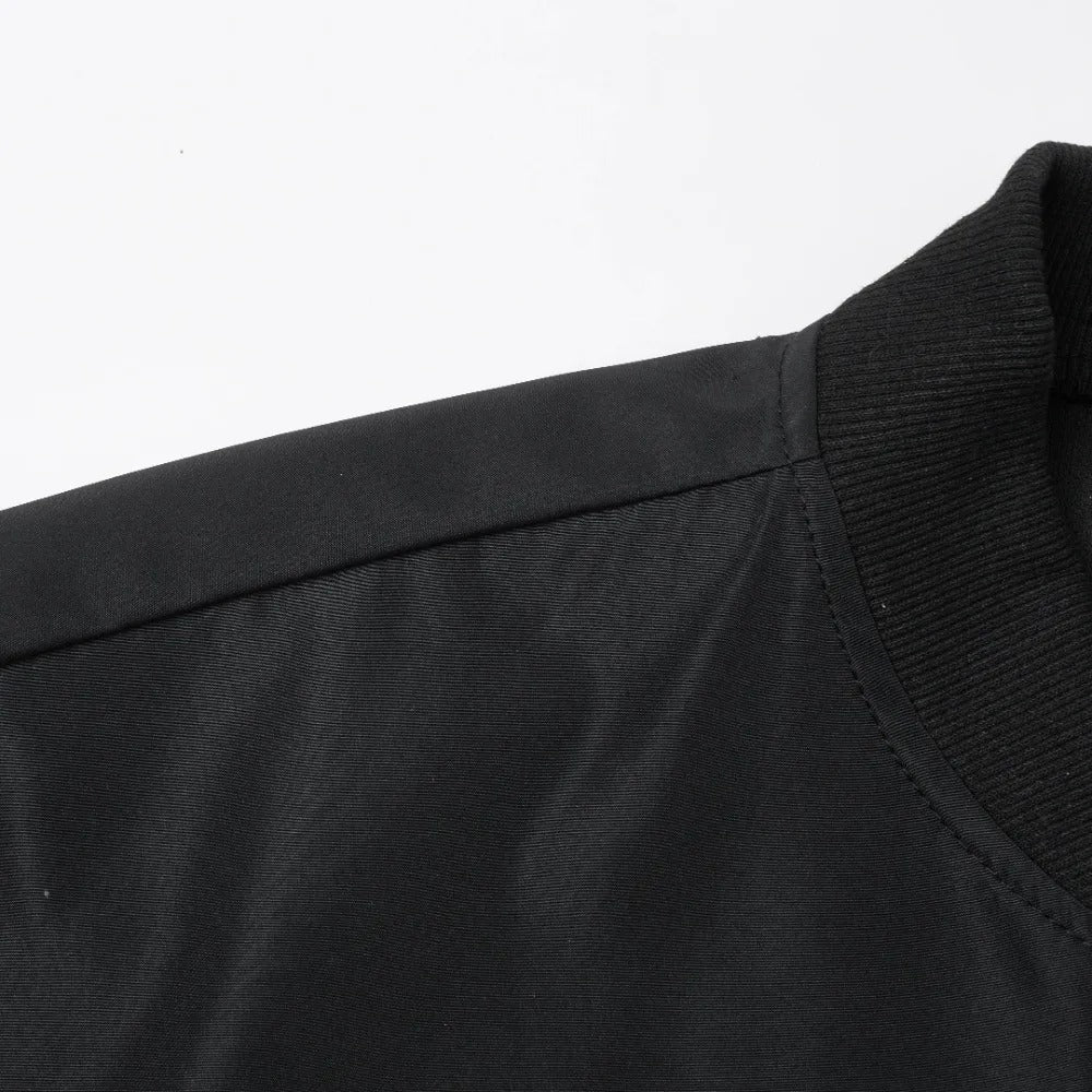 Close-up of zipper and ribbed sleeve design on men’s baseball collar coat.